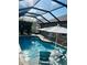 Inviting backyard pool area with comfortable seating and a screened enclosure at 7508 Mikasa Dr, Punta Gorda, FL 33950