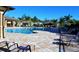 Community pool featuring resort style seating, a splash area, and surrounding palm trees at 7508 Mikasa Dr, Punta Gorda, FL 33950