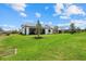 Spacious backyard showcasing the patio, green lawn, and surrounding landscape of the property at 7765 Grande Shores Dr, Sarasota, FL 34240
