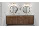 Bathroom features a double vanity with round mirrors, quartz counters and modern light fixtures at 7765 Grande Shores Dr, Sarasota, FL 34240