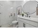Modern bathroom with a glass shower, and a floating sink with marble countertops at 7765 Grande Shores Dr, Sarasota, FL 34240