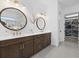 Bathroom features a double vanity with round mirrors and a walk-in closet with shoe storage at 7765 Grande Shores Dr, Sarasota, FL 34240