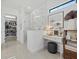 Bathroom boasts a walk-in shower with marble-look tile and vanity area with a makeup mirror at 7765 Grande Shores Dr, Sarasota, FL 34240