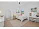 Bright bedroom with neutral tones features a large mirror, and beachy decor at 7765 Grande Shores Dr, Sarasota, FL 34240
