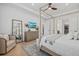 Bright bedroom features a wood canopy bed, neutral decor, and access to walk-in closet at 7765 Grande Shores Dr, Sarasota, FL 34240