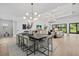 Bright dining space with modern chandelier, table setting, and open access to the living area at 7765 Grande Shores Dr, Sarasota, FL 34240