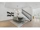 Dining room with modern chandelier, seating for eight, hardwood floors and staircase access at 7765 Grande Shores Dr, Sarasota, FL 34240