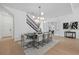 Dining room with contemporary chandelier, table seating for eight, and a view of the foyer at 7765 Grande Shores Dr, Sarasota, FL 34240