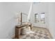 Bright foyer featuring a wooden table, stylish accents, a patterned rug, and views of the entry doors at 7765 Grande Shores Dr, Sarasota, FL 34240