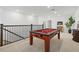 Bright game room with a pool table, modern painting and neutral colors at 7765 Grande Shores Dr, Sarasota, FL 34240