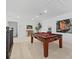 Game room features a pool table with a modern painting at 7765 Grande Shores Dr, Sarasota, FL 34240