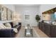 Cozy living room with a plush leather sofa, stylish decor, and a large flat screen TV at 7765 Grande Shores Dr, Sarasota, FL 34240