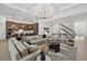View of a large living room with hardwood floors and open access to dining and kitchen area at 7765 Grande Shores Dr, Sarasota, FL 34240