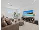 Comfortable living room boasts a large flatscreen tv, and natural lighting with plantation shutters at 7765 Grande Shores Dr, Sarasota, FL 34240