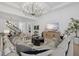 Open-concept living room showcases a statement chandelier and stylish, neutral decor at 7765 Grande Shores Dr, Sarasota, FL 34240