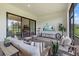 Stylish outdoor living space with comfortable seating, an entertainment center, and serene views of the outdoors at 7765 Grande Shores Dr, Sarasota, FL 34240