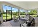 Cozy outdoor living area with an outdoor kitchen and serene views of the yard at 7765 Grande Shores Dr, Sarasota, FL 34240