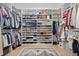 Custom walk-in closet boasts ample storage space for clothing, shoes, and accessories at 7765 Grande Shores Dr, Sarasota, FL 34240