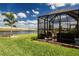 Relaxing screened-in patio with comfortable seating and serene pond views at 8232 Reefbay Cv, Parrish, FL 34219