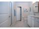 Bright bathroom featuring a glass shower, neutral tile floors, and a vanity with a sleek countertop at 8232 Reefbay Cv, Parrish, FL 34219