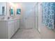 Neutral bathroom showcasing a shower with glass doors, dual sink vanity, and modern finishes at 8232 Reefbay Cv, Parrish, FL 34219