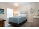 Bright bedroom featuring a blue and white bedspread, stylish chandelier, and coastal-themed decor at 8232 Reefbay Cv, Parrish, FL 34219