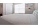 Bright bedroom with neutral carpet, bright windows with blinds, and tasteful decor and artwork at 8232 Reefbay Cv, Parrish, FL 34219