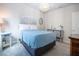 Inviting bedroom with charming decor, a blue and white bedspread, and a decorative chandelier at 8232 Reefbay Cv, Parrish, FL 34219