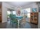 Bright dining room area features a slider leading to a screened lanai with backyard views at 8232 Reefbay Cv, Parrish, FL 34219
