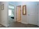Hallway view into a bedroom with natural light and neutral tones, showcasing modern flooring and decor at 8232 Reefbay Cv, Parrish, FL 34219