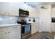 Bright kitchen boasts white cabinets, stainless steel appliances, and stylish backsplash at 8232 Reefbay Cv, Parrish, FL 34219