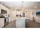 Modern kitchen with stainless steel appliances, white cabinetry, and a large center island at 8232 Reefbay Cv, Parrish, FL 34219
