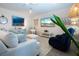 Comfortable living room featuring a plush sofa, artwork, and stylish coastal-themed decor at 8232 Reefbay Cv, Parrish, FL 34219