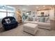 Cozy living area with a plush white sofa and a comfortable blue armchair at 8232 Reefbay Cv, Parrish, FL 34219