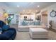 Bright living room boasts modern furniture and coastal decor flowing into the kitchen at 8232 Reefbay Cv, Parrish, FL 34219