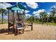 Wooden playground features a climbing structure and slide, offering fun and engaging activities for children at 8232 Reefbay Cv, Parrish, FL 34219