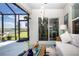 Screened porch with comfortable seating, ceiling fan, and views of the water at 8232 Reefbay Cv, Parrish, FL 34219