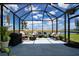 Open screened porch with comfortable seating and scenic water views at 8232 Reefbay Cv, Parrish, FL 34219