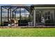 Expansive screened-in porch with cozy seating and backyard views at 8232 Reefbay Cv, Parrish, FL 34219