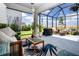 Relaxing screened porch with comfortable seating, stylish rug, and views of the backyard at 8232 Reefbay Cv, Parrish, FL 34219