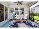Cozy screened porch featuring outdoor furniture, stylish rug, and tranquil backyard views at 8232 Reefbay Cv, Parrish, FL 34219