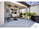 Inviting screened porch featuring comfortable furniture, a ceiling fan, and scenic outdoor views at 8232 Reefbay Cv, Parrish, FL 34219