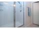 Close-up of a shower featuring bright white subway tile, a glass door, and modern fixtures at 8232 Reefbay Cv, Parrish, FL 34219