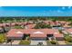 Aerial view of the community featuring mature trees, lakes, a golf course and community pool at 892 Country Club Cir # 50, Venice, FL 34293