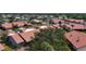 This aerial view highlights the red tile roofs, landscaping, and community layout at 892 Country Club Cir # 50, Venice, FL 34293