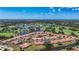 Aerial view of the community featuring mature trees, lakes, a golf course and stunning water views at 892 Country Club Cir # 50, Venice, FL 34293