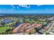 Stunning aerial view showcases the community's layout, green spaces, lakes and the nearby ocean at 892 Country Club Cir # 50, Venice, FL 34293