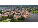 Beautiful aerial view of the community with lush landscaping, lake views, and a community pool at 892 Country Club Cir # 50, Venice, FL 34293