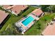 Aerial view of community pool, set between the residences with ample sunbathing chairs at 892 Country Club Cir # 50, Venice, FL 34293