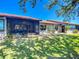 This spacious backyard has a screened-in lanai, a seating area, and a well manicured lawn at 892 Country Club Cir # 50, Venice, FL 34293